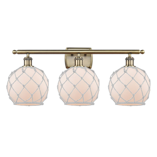 Innovations Farmhouse Rope 28in 3-Light Bath Vanity Light | Industrial Antique Brass and White Frosted Glass Rope Shade | Model 516-3W-AB-G121-8RW