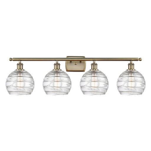 Innovations Athens Deco Swirl 38in 4-Light Bath Vanity Light | Industrial Antique Brass Steel and Clear Deco Swirl Glass | Model 516-4W-AB-G1213-8CL