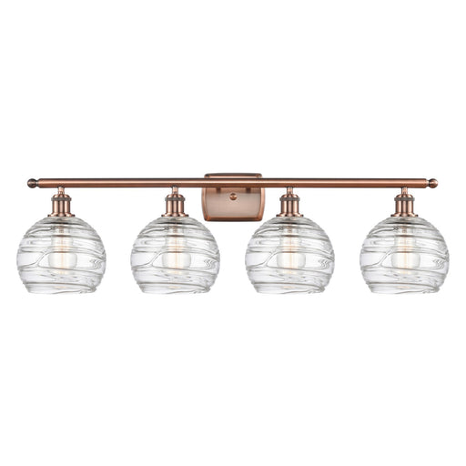 Innovations Athens Deco Swirl 38in 4-Light Bath Vanity Light | Industrial Antique Copper and Clear Deco Swirl Glass | Bathroom | Model 516-4W-AC-G1213-8CL