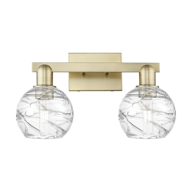 Innovations Athens Deco Swirl 16.88in 2-Light Bath Vanity Light | Industrial Antique Brass Steel and Clear Deco Swirl Glass | Model 716-2W-AB-G1213-6CL