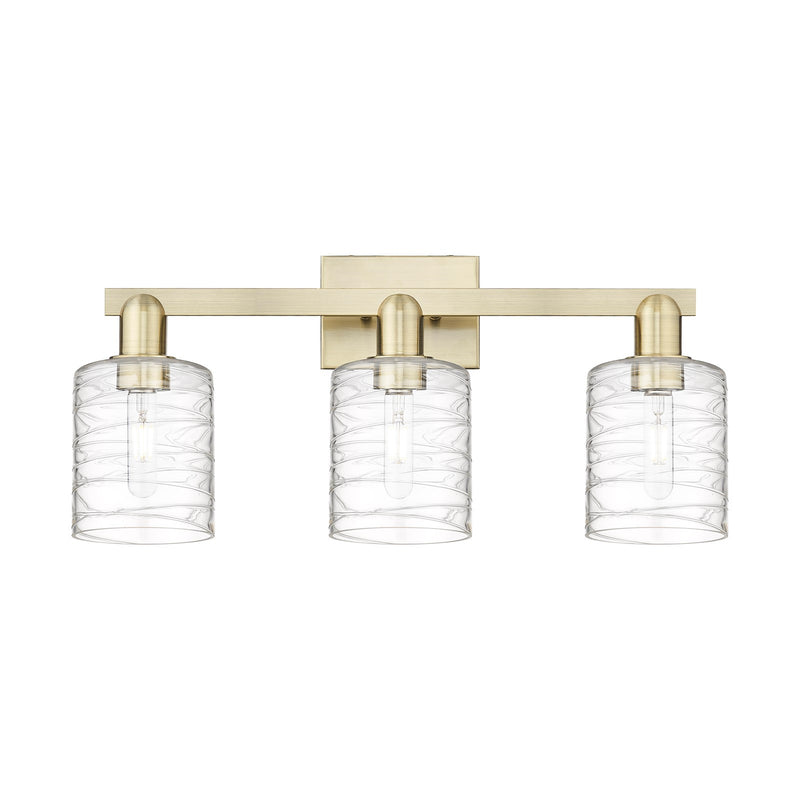 Innovations Cobbleskill 24in 3-Light Bath Vanity Light | Industrial Antique Brass and Deco Swirl Clear Glass | Bathroom Vanity | Model 716-3W-AB-G1113