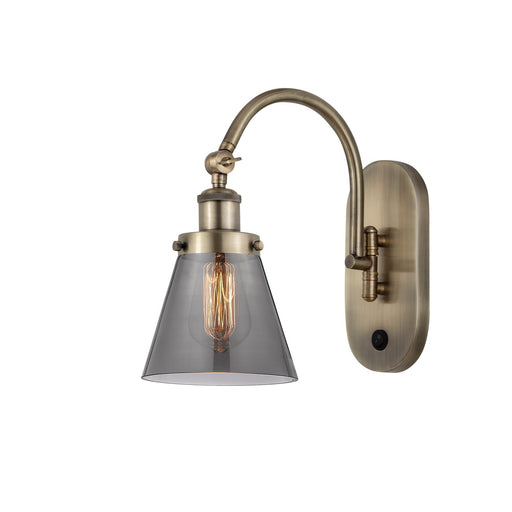 Innovations Cone 6.25in 1-Light Swing Arm Sconce | Industrial Antique Brass and Light Smoke Glass | Bedroom & Hallway Accent Light | Model 918-1W-AB-G63