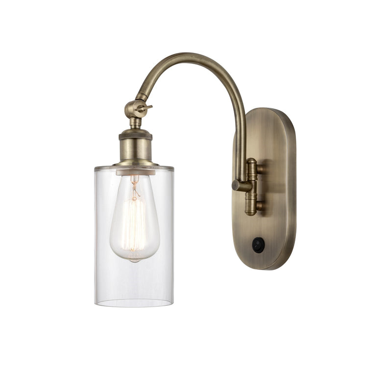Innovations Clymer 4in 1-Light Wall Sconce | Industrial Antique Brass and Clear Glass | Bedroom & Hallway Accent | 3.88 x 12.88 in | Model 918-1W-AB-G802